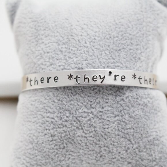 *There *They're *Their - Hand Stamped Anodized Aluminum Bangle - Adjustable - Picture 13 of 14